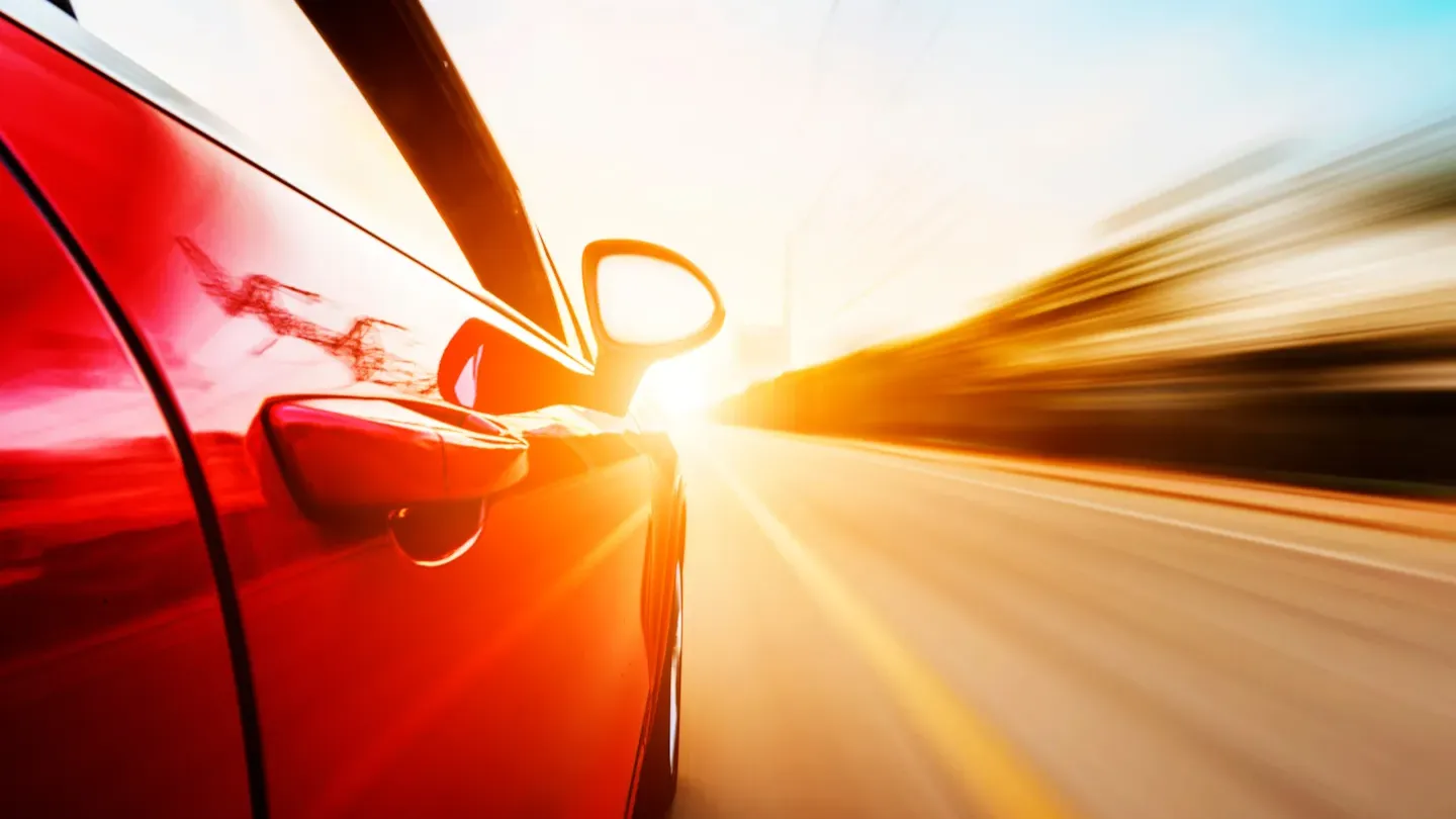 Abstract cybersecurity visual showing a vehicle in motion with digital threat indicators representing cyber-risk awareness and response