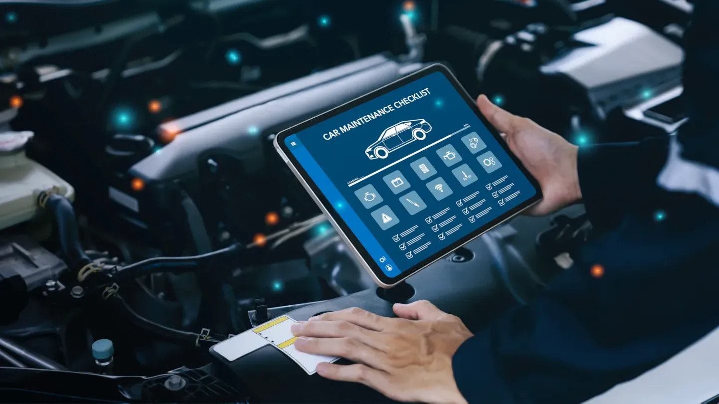 Automotive engineer using a digital diagnostic tablet to evaluate software performance and verify ASPICE process compliance