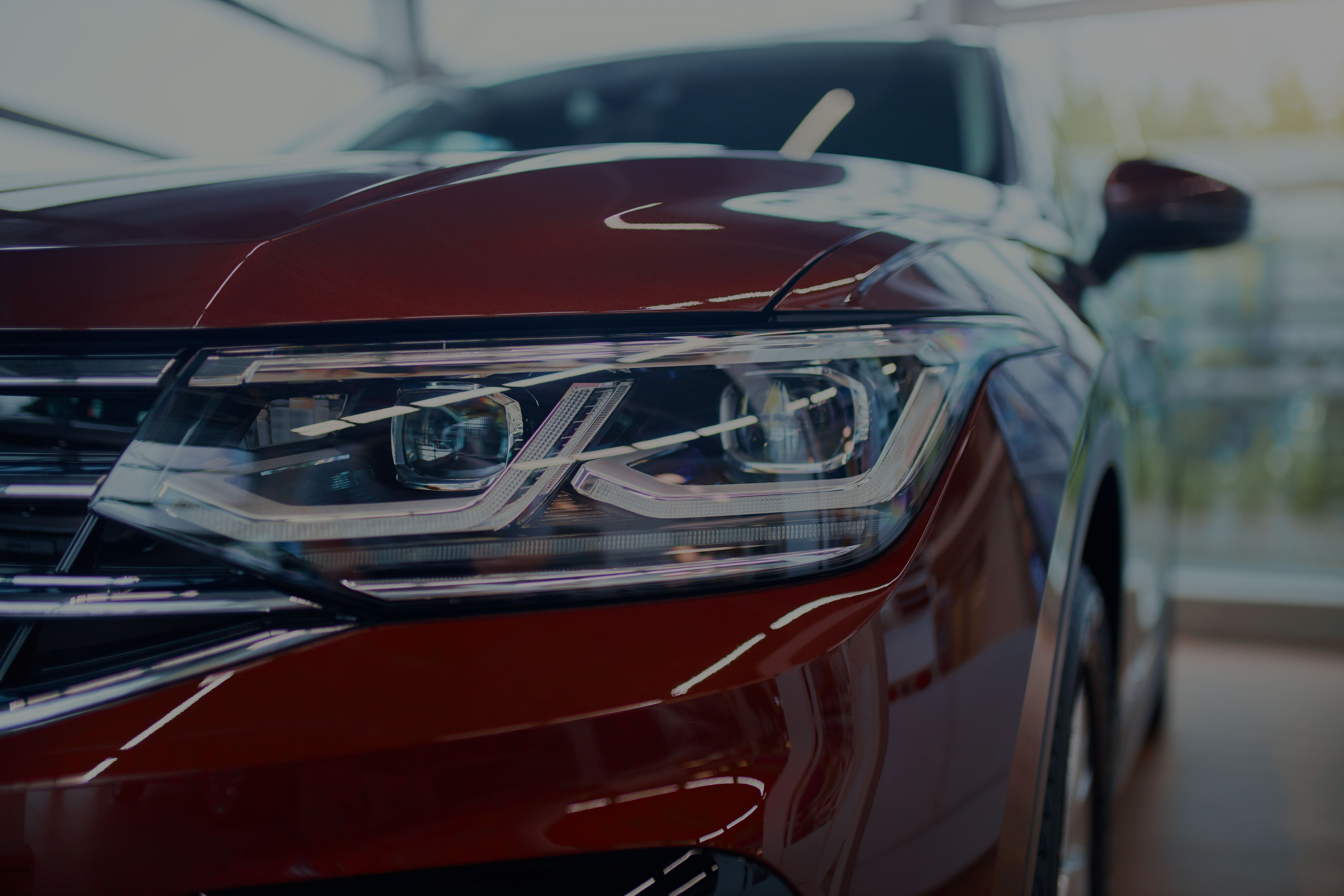Close-up of a modern car headlight and front grille, symbolizing high-quality automotive software and ASPICE-aligned development