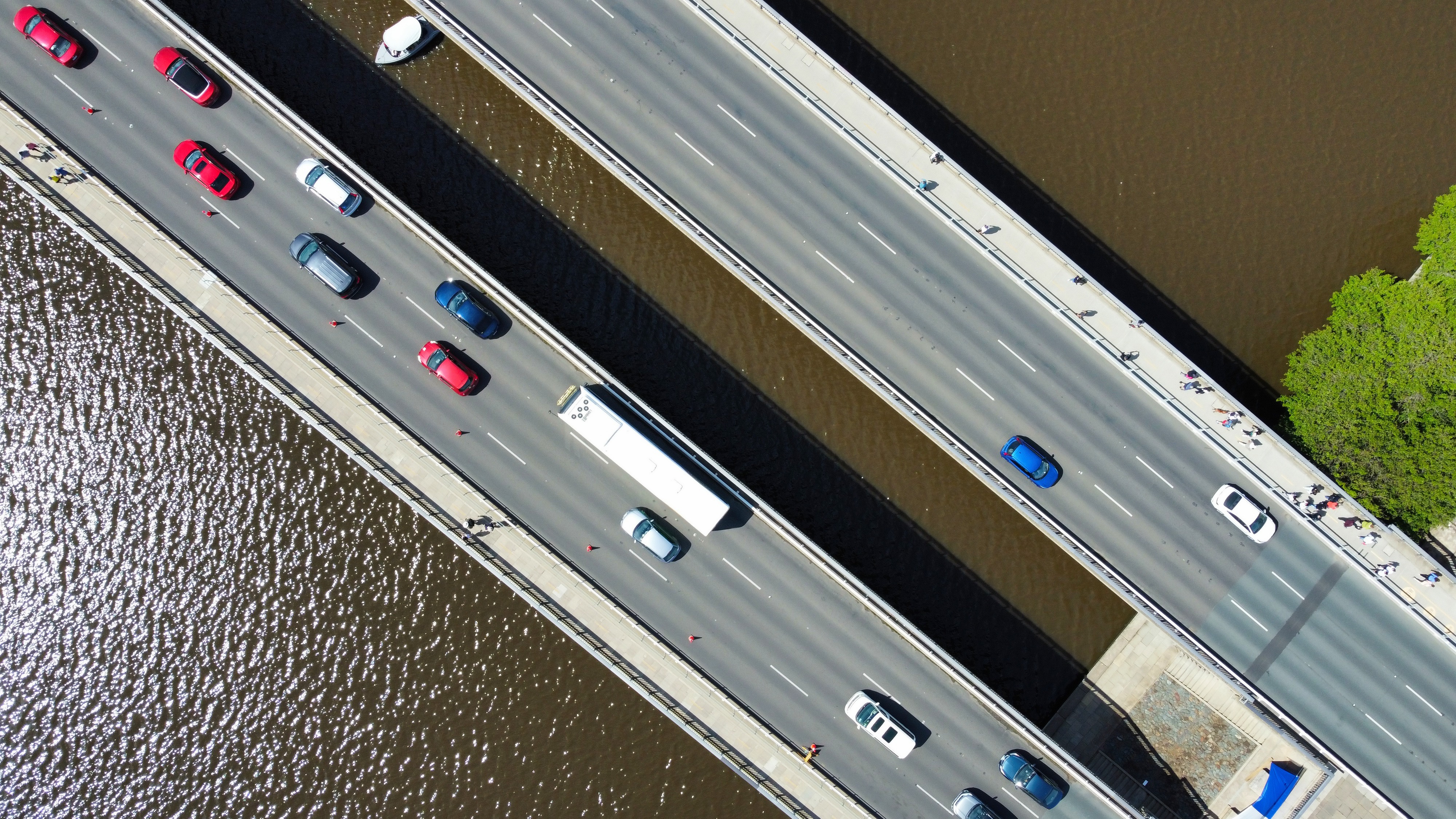 Overhead view of cars crossing a multi-lane bridge over water, symbolising predictive reliability and performance of automotive fleets