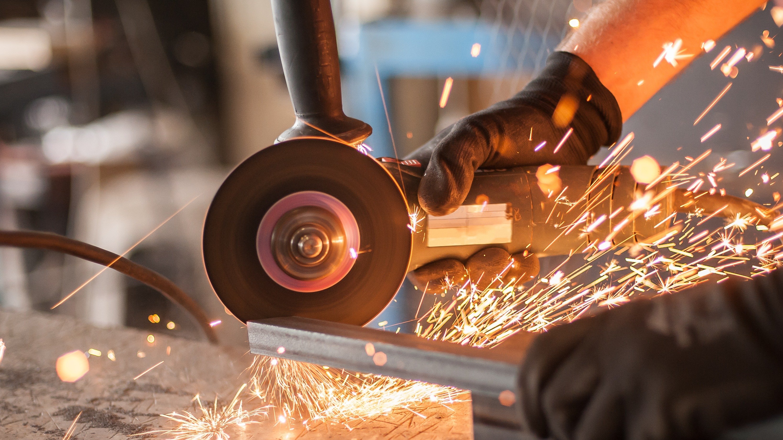 Steelworker cutting metal in a factory, symbolizing sustainable steel production and ResponsibleSteel™ certification.