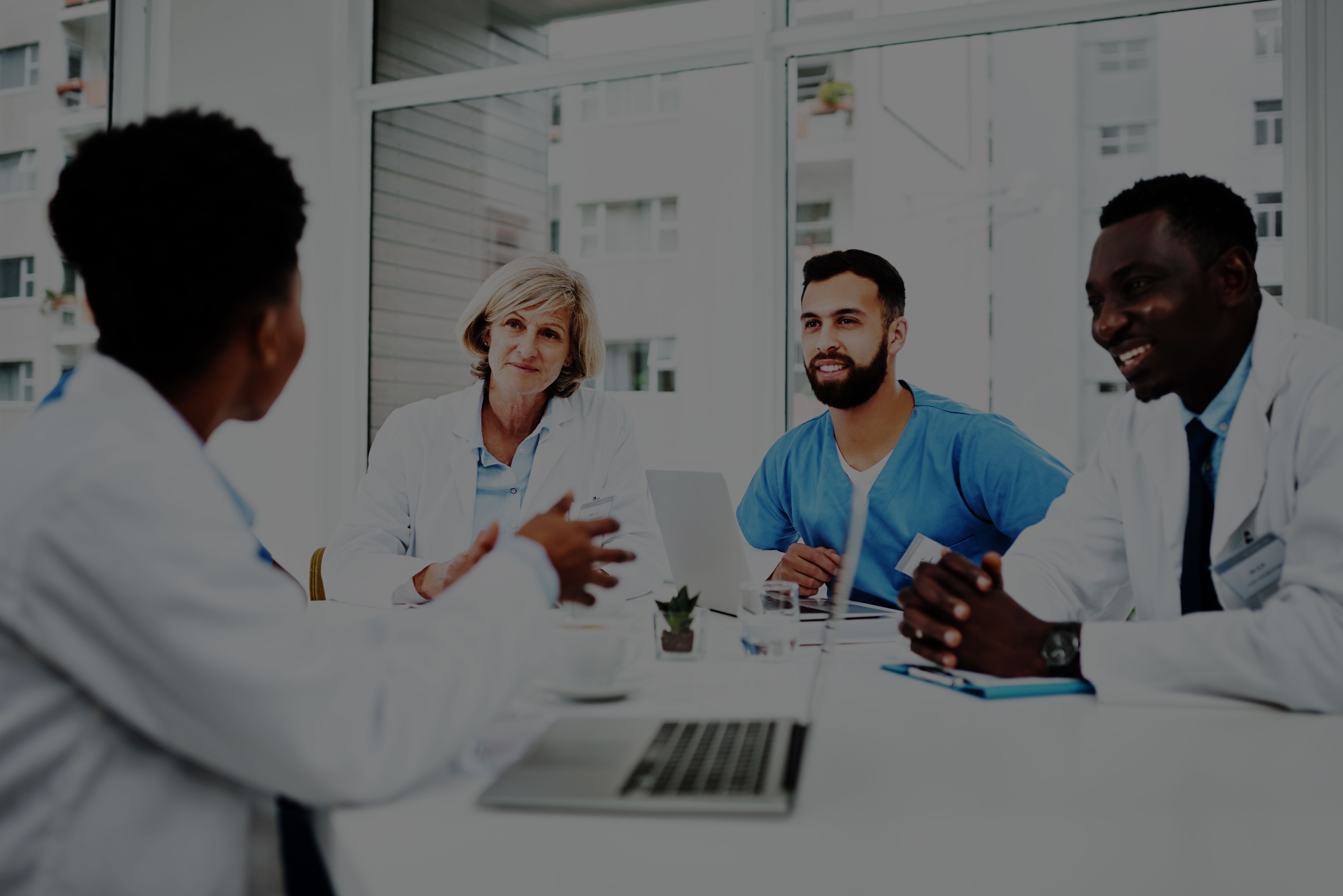 Healthcare professionals reviewing accreditation documents in a hospital corridor, symbolizing DNV’s commitment to quality and patient safety