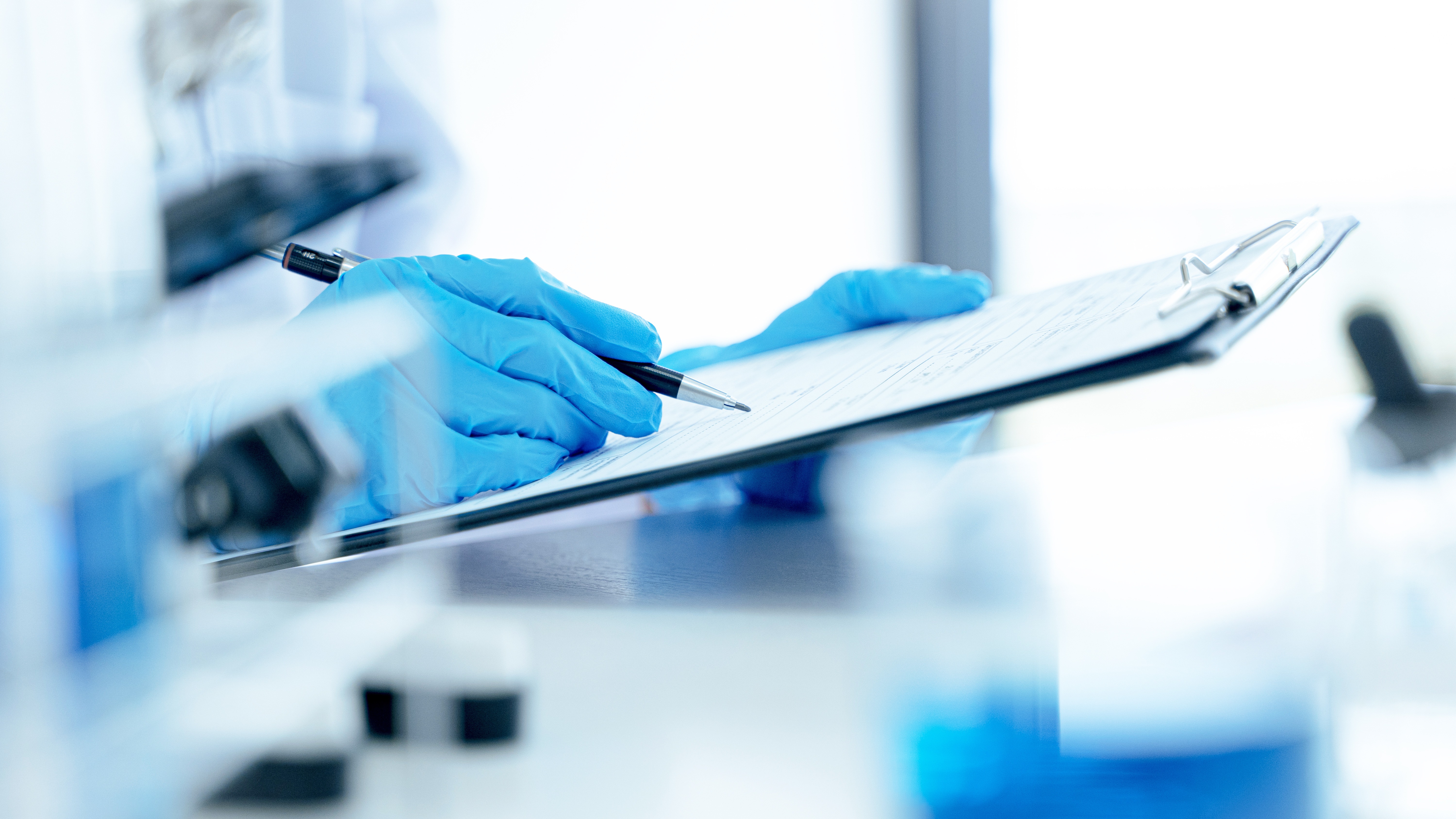 Close-up of a medical device auditor reviewing documentation during a quality management system assessment for MDSAP certification.