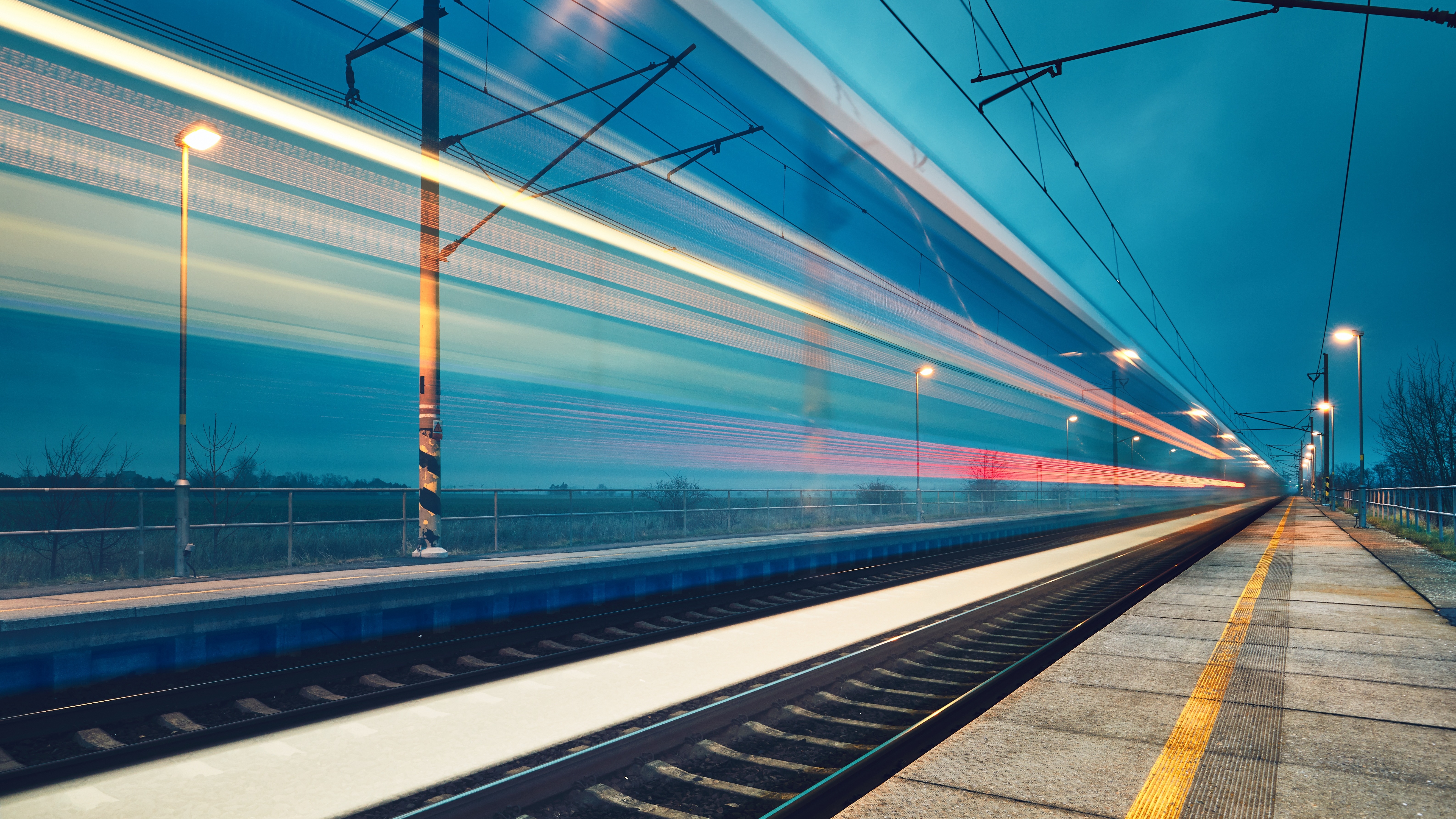 High-speed train on modern rail infrastructure at dusk, representing secure digital rail operations and cybersecurity resilience.