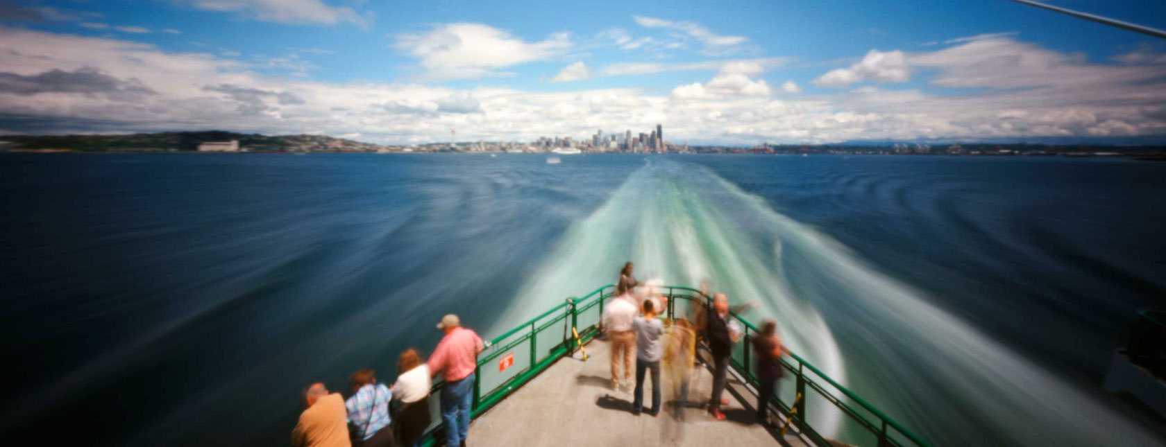 Passenger ferry pulling away from a city