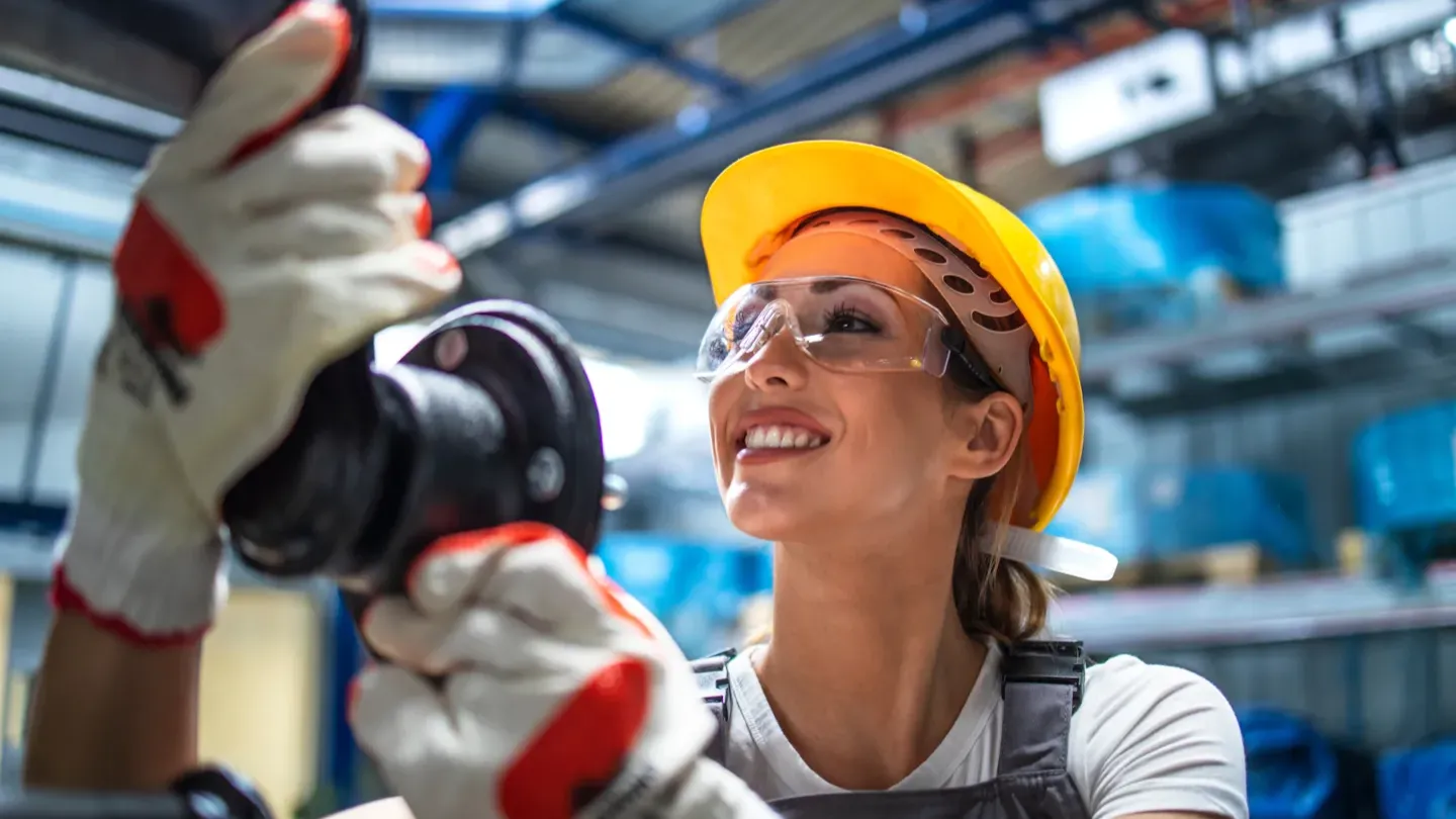 Instructor coaching an automotive engineer wearing safety gear, representing applied ISO 26262 training and real-world skills development