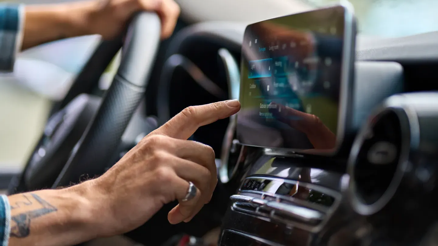 Engineer reviewing automotive system data on an in-car touchscreen to assess ASPICE process gaps and improvement needs
