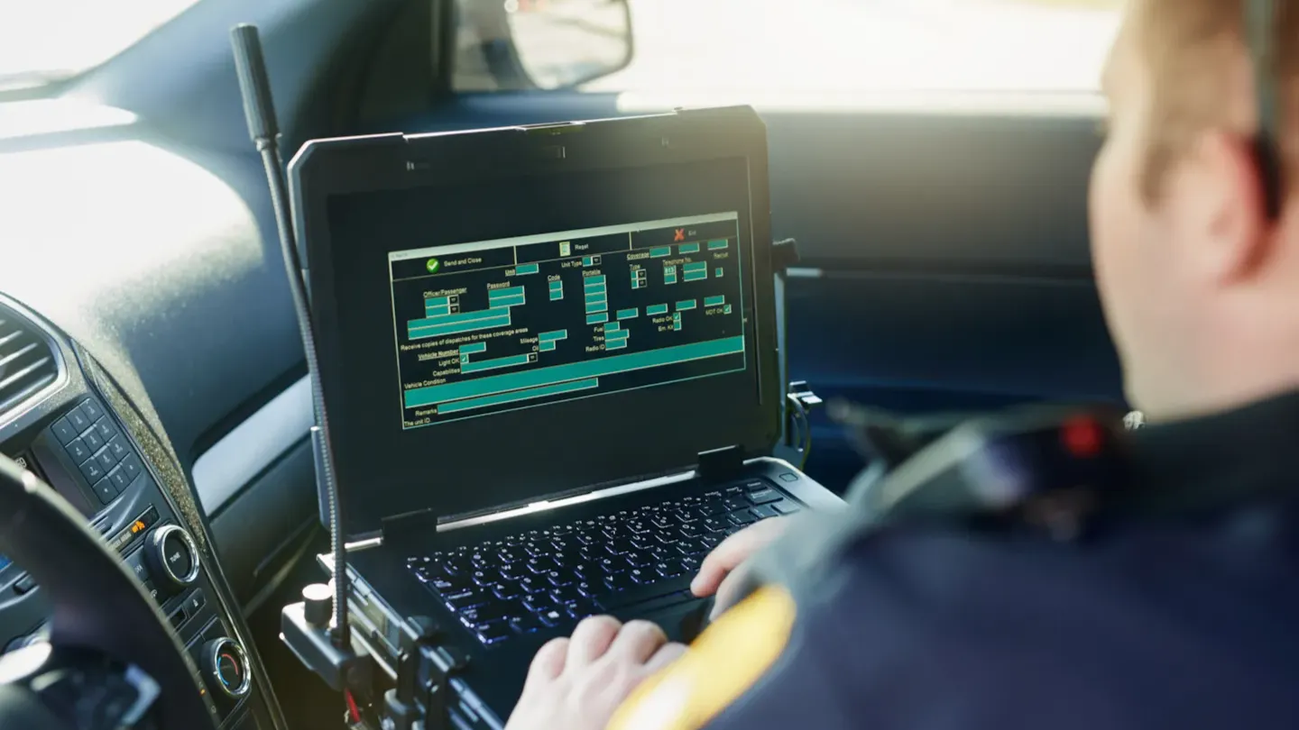 Automotive technician reviewing vehicle system data on a laptop during cybersecurity awareness and diagnostic training