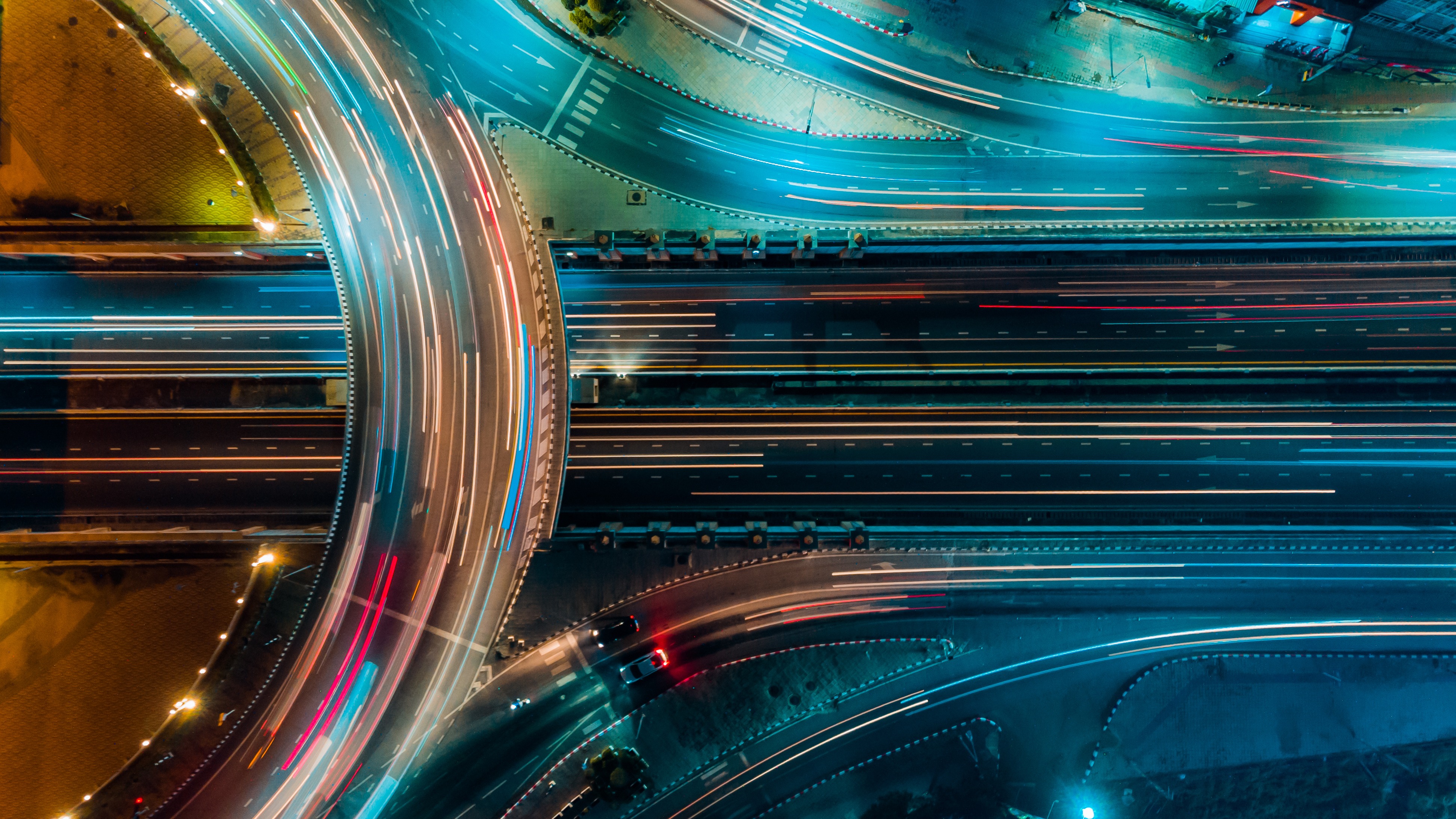 Abstract overhead view of multilane traffic with light trails and digital overlays representing automotive risk and reliability analysis