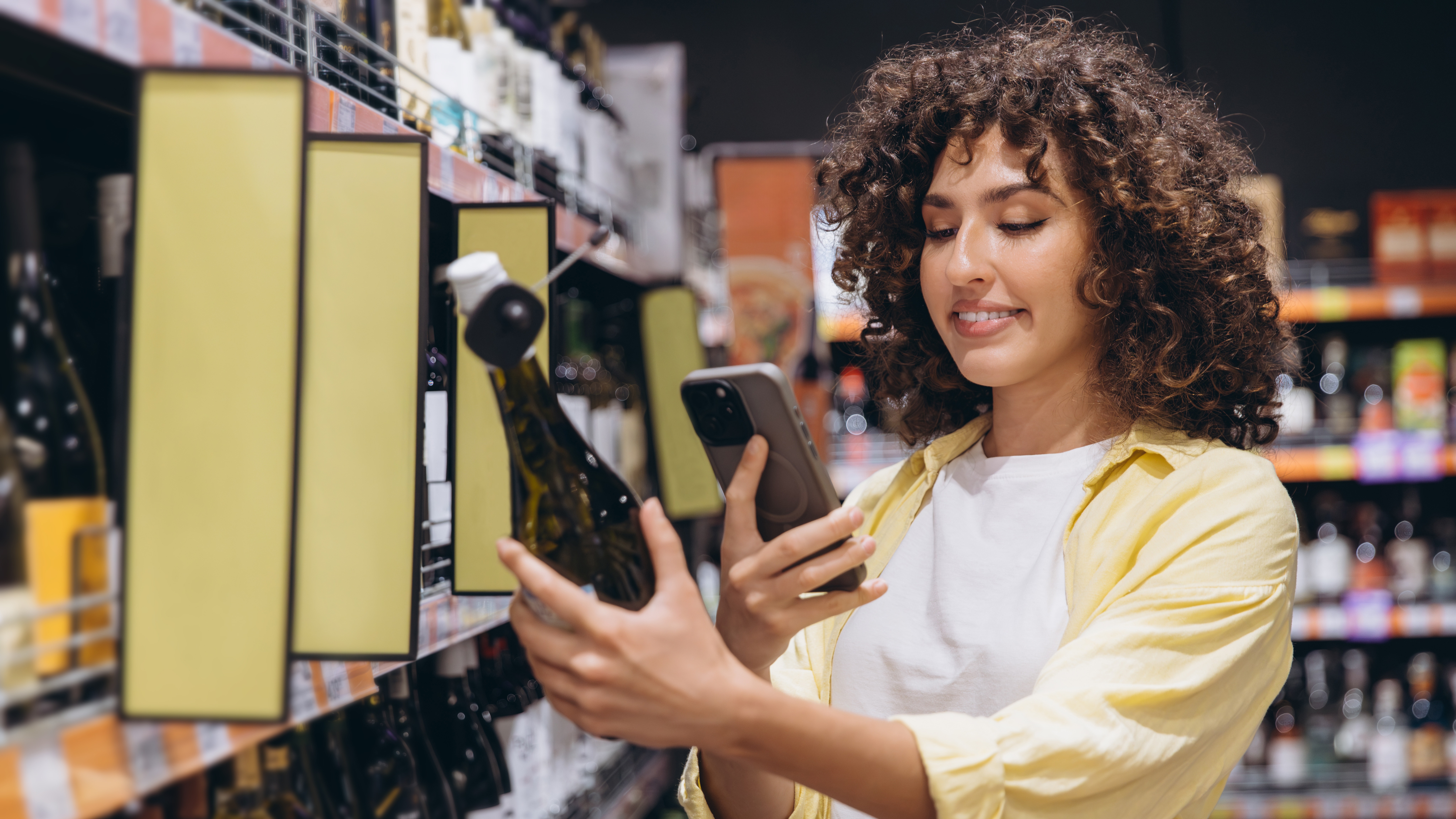 Professional woman scanning a packaged product in a retail environment, representing DNV’s digital product passport and traceability assurance services.
