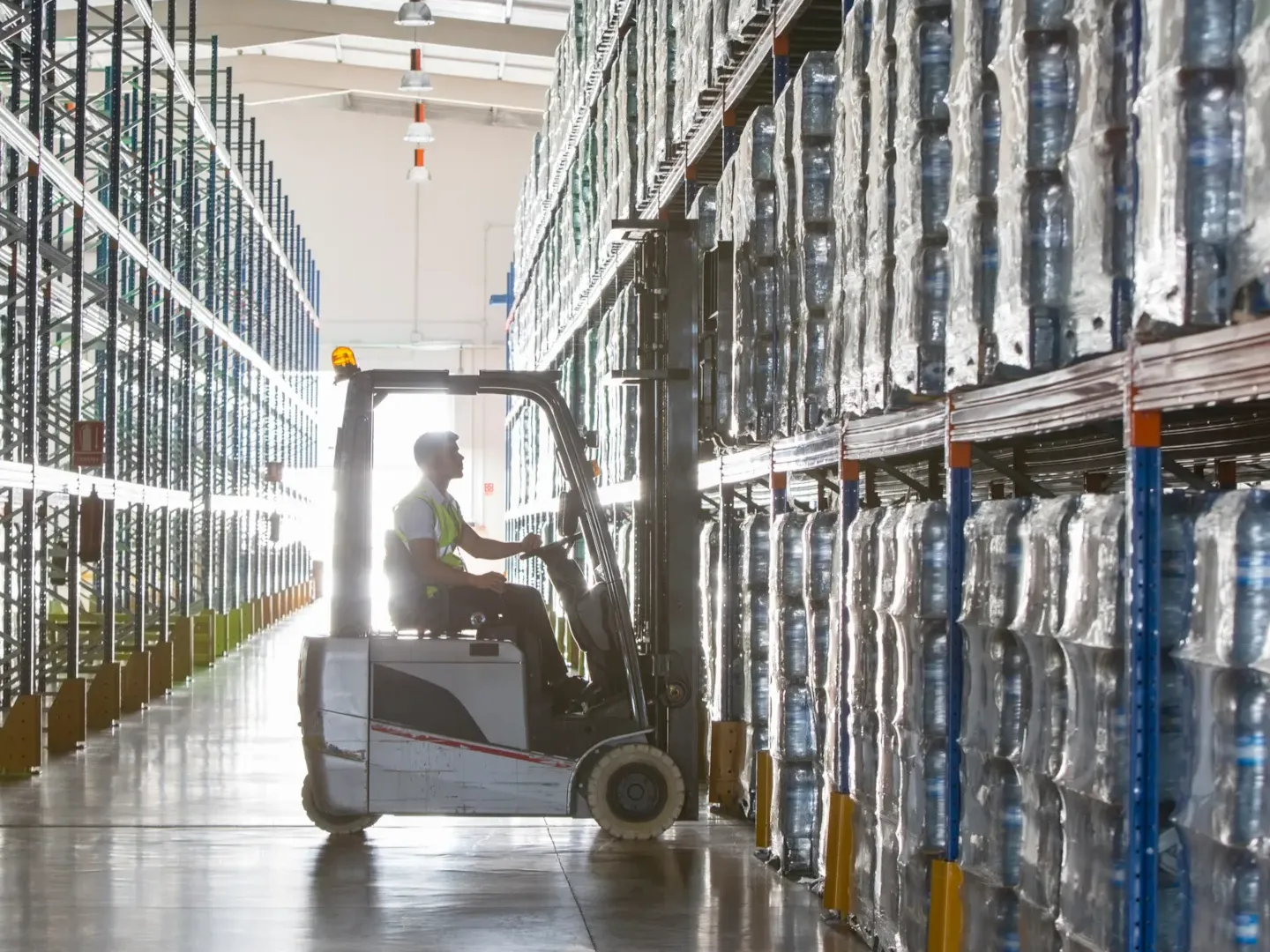 Interior of a modern warehouse with high industrial shelving, symbolizing supply chain data management and scalable digital product passport architecture