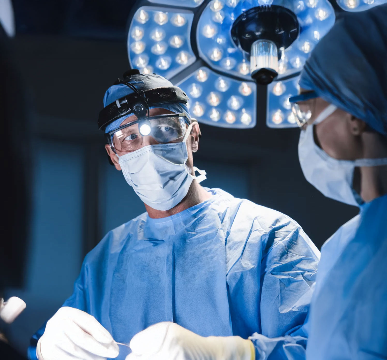 Healthcare professionals handling sterile packaged surgical instruments, demonstrating safe instrument processing procedures