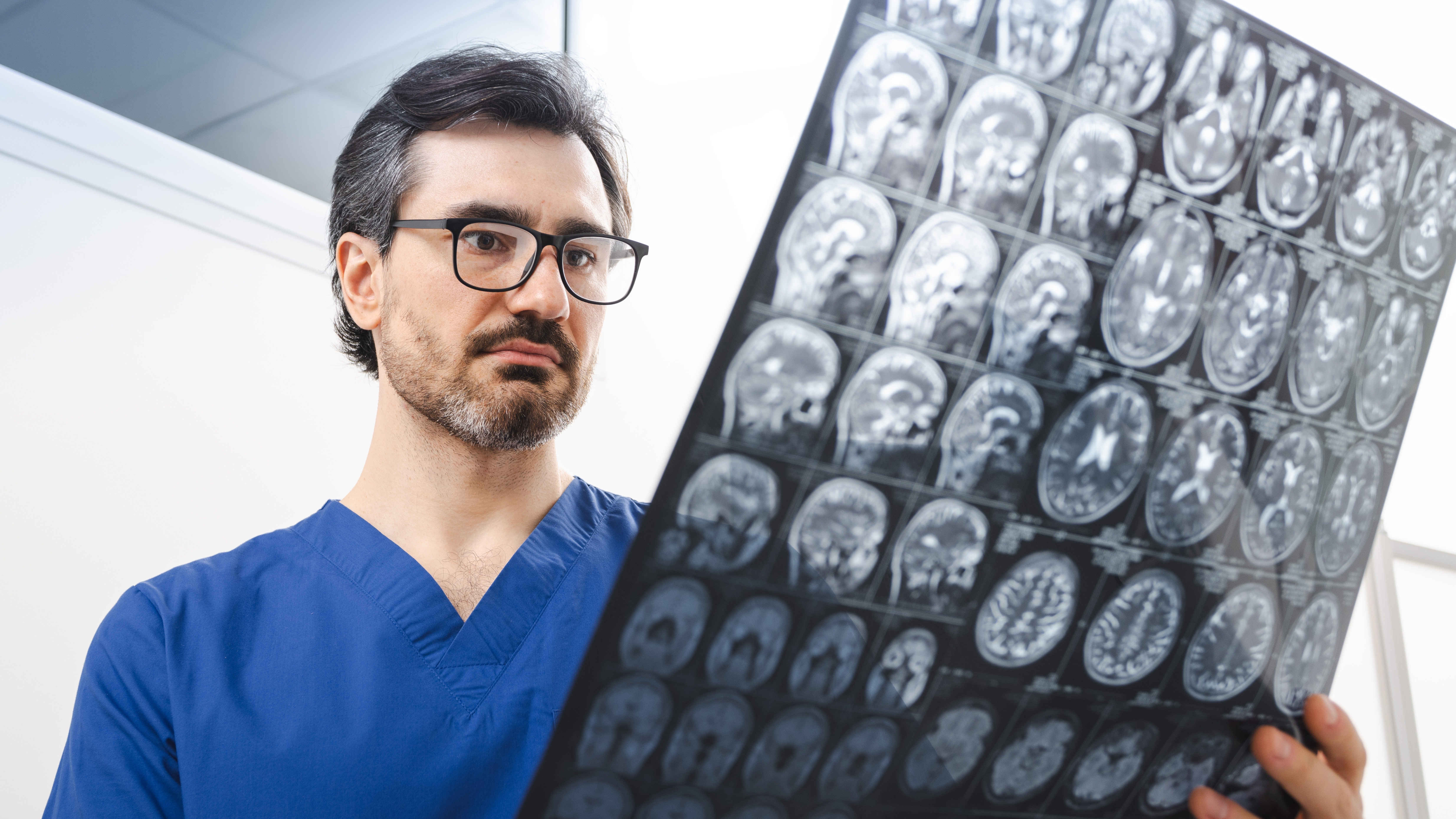 Healthcare professional reviewing brain scans beside a mobile stroke ambulance, symbolizing rapid response and prehospital stroke care excellence.