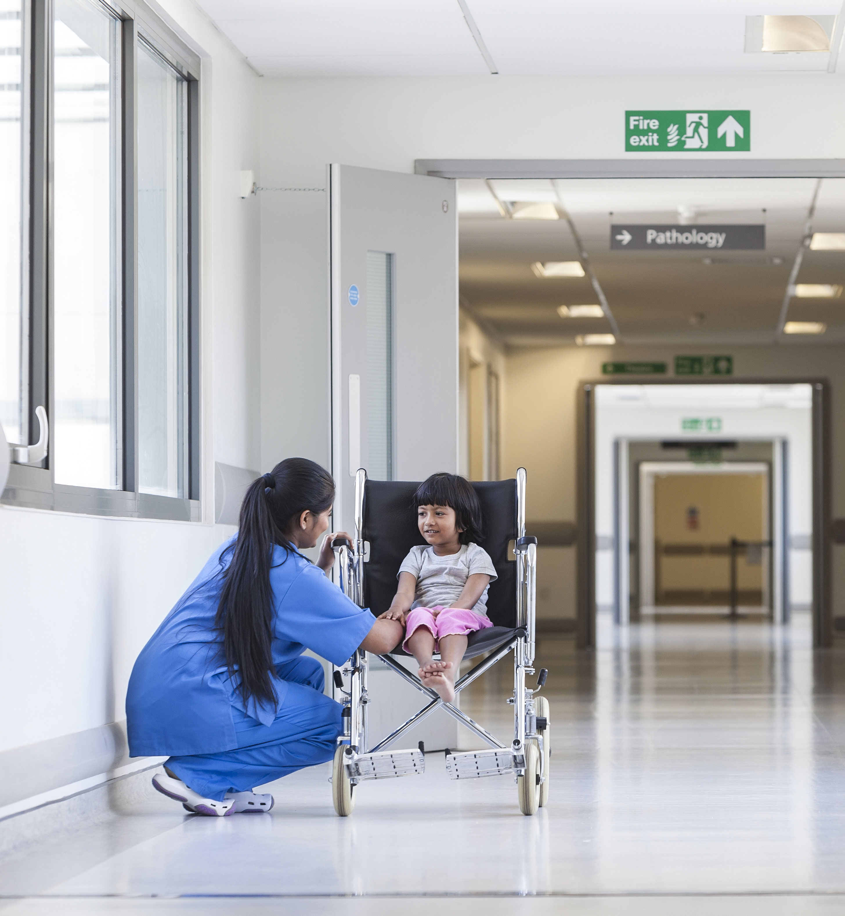 Nurse supporting a pediatric patient in a hospital corridor, illustrating safe, coordinated, and proactive infection prevention practices under DNV’s Advanced Certification in Infection Prevention