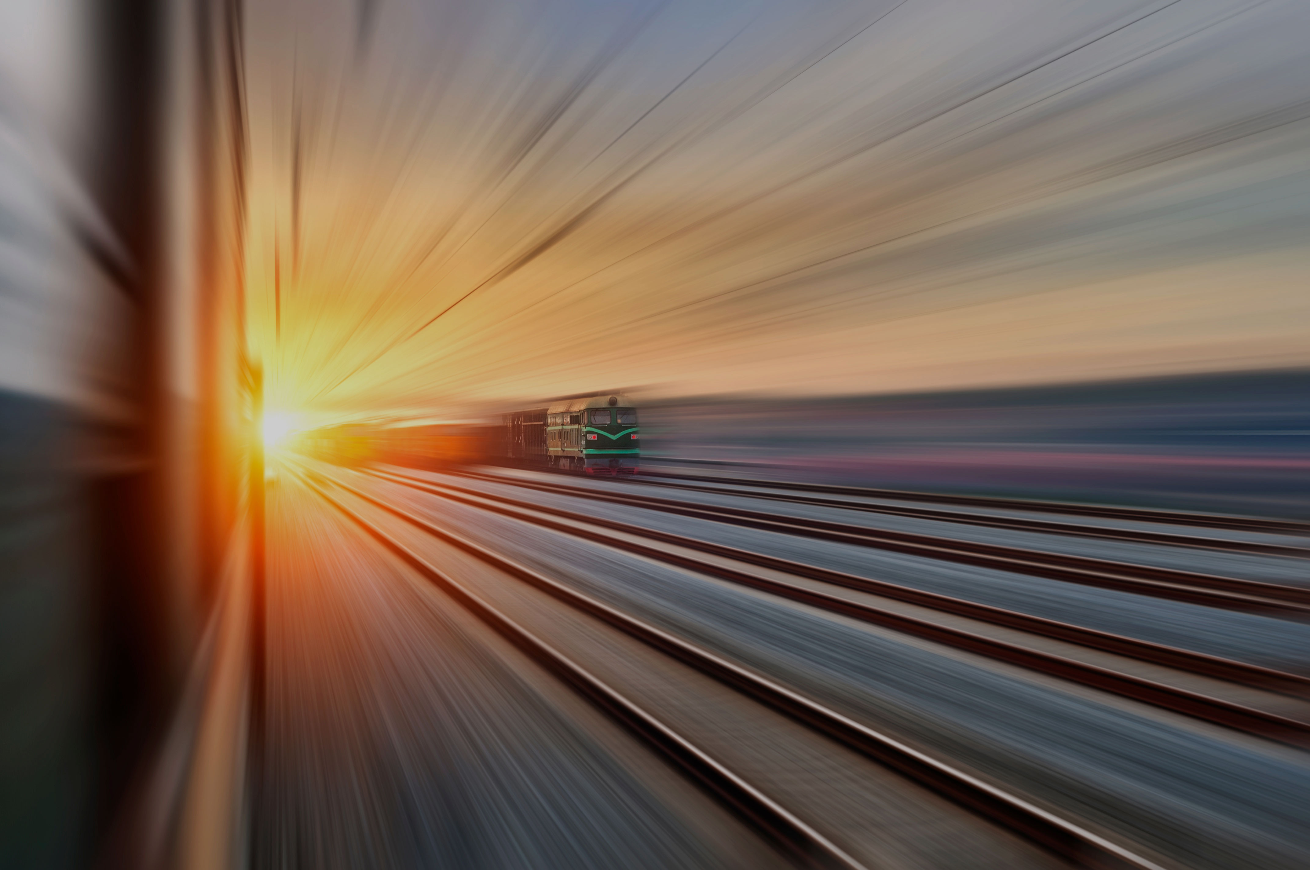 High-speed train in motion with digital light trails representing railway cybersecurity and data protection.