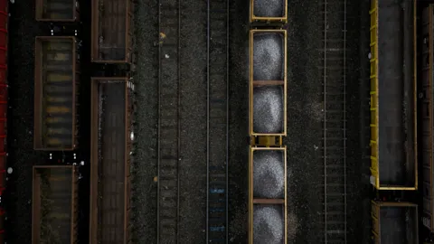 Modern rail infrastructure and trains viewed from above, illustrating regulatory compliance in the railway sector