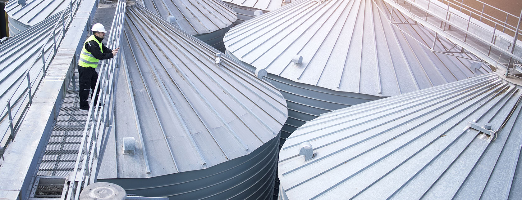 worker overlooking silos