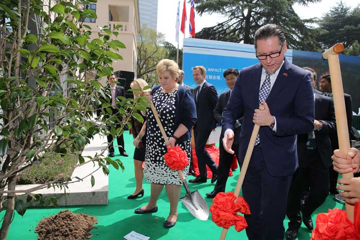 Norwegian PM Erna Solberg and DNV GL Group President & CEO Remi Eriksen planting a tree as a symbol for sustainability at the new Shanghai office