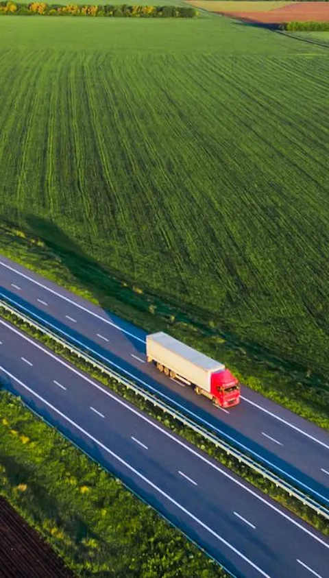 Truck on road between fields